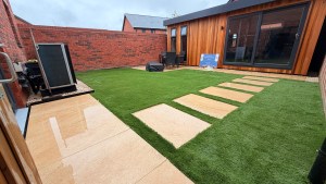 New porcelain patio with stepping stone and artificial lawn